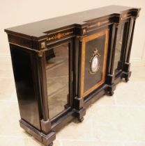 A Victorian ebonised and walnut banded credenza, the central cupboard door inset with an oval French