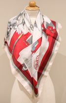 An Hermes silk scarf, in the 'Attelages' pattern, in pink, grey, and red tones, with rolled hems,