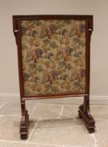 A Victorian walnut framed country house fire screen, late 19th century, the angular frame