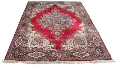 A Lister caliph wool pile Wilton Persian style carpet, the central foliate medallion of vibrant