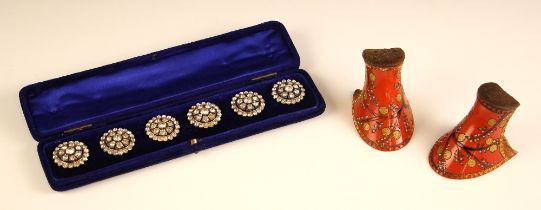 A cased set of 20th century paste set buttons, the stylised flower head designed button with