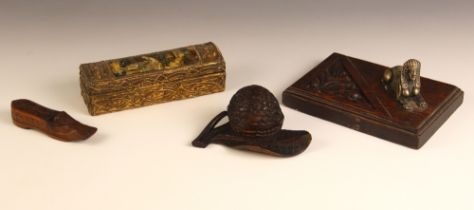 A Swiss novelty carved wooden box and cover, early 20th century, modelled as a nut resting on a