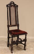 A 17th century ebonised Carolean hall chair, the high back with cane work panel, upon baluster and