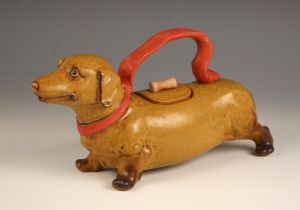 A novelty Japanese pottery teapot in the form of a Dachshund, modelled standing with removable cover