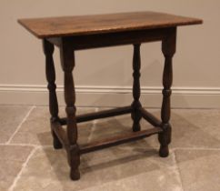An early 18th century jointed oak rectangular occasional table, the three plank top upon twin