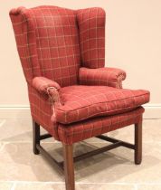 A George III style wingback armchair, later re-covered in red tartan fabric, the shaped wingbacks