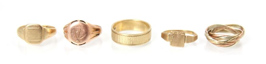 A selection of five 9ct yellow gold and yellow metal rings, including three signet ring examples,