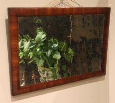 A Victorian mahogany framed wall mirror, of rectangular cushion form, enclosing a bevelled