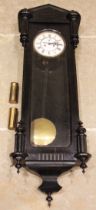A Victorian ebonised cased twin weight Vienna wall clock, the architectural case with fluted