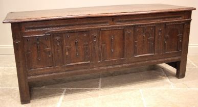 A 17th/18th century oak coffer, the moulded plank top opening to a later lined interior and a fitted