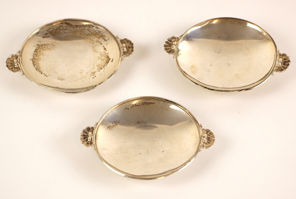 A set of three Georg Jensen trinket dishes, the oval dishes with twin debossed shell handles,