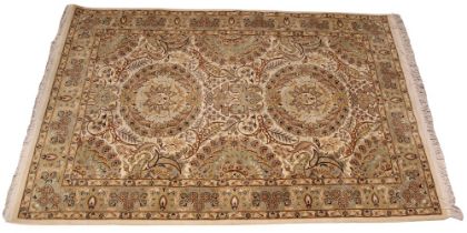 A Pakistan Isfahan hand woven wool rug, in autumnal colourways, the two central circular foliate