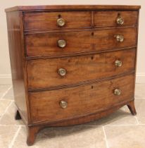 A George IV mahogany bowfront secretarie chest of drawers, the fall front moulded as two short and