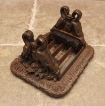 A Victorian style cast iron boot scrape, the sides modelled as two cranes drinking from an urn, upon