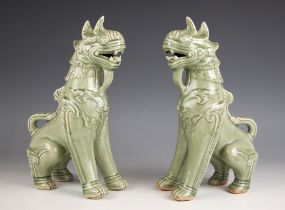 A pair of Siam Celadon porcelain figures of Qilin, 20th century, each modelled seated, stamped to