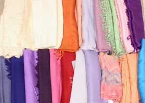 A collection of wool and cashmere scarves, with twist tasseled ends in colours to include; green,