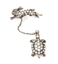 A 19th century style paste set ‘hare and tortoise’ brooch, the hare set with round cut paste with