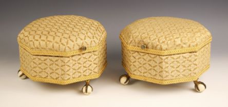 A pair of Victorian upholstered octagonal footstools, with hinged covers, upon three brass claw