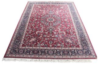 A Royal Keshan wool carpet, the all over foliate design in red, blue and ivory colourways, 274cm x