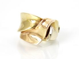 A yellow metal dress ring, the stylised ribbon detailed ring with wide plain polished band, ring