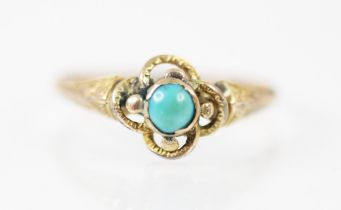 A late 19th century untested turquoise ring, the round cut turquoise set in a yellow metal rubover