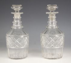 A pair of cut glass decanters, 19th century, each of mallet form, with triple knopped neck,