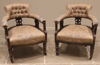 An Edwardian three piece stained beech salon suite, comprising a pair of button back tub chairs, the