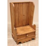 A Welsh child's pine lambing chair, 19th century and later, the high back with shaped wing backs