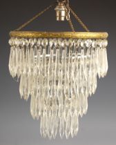 A pair of Edwardian three tiered chandeliers, early 20th century, each of typical concentric