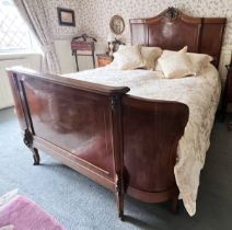 A French Louis XV style walnut double bed, early to mid 20th century, the break arch headboard