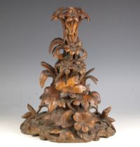 A Black Forest carved table centre, 19th century, modelled as entwined flora and foliage rising from