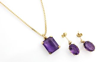 An amethyst set pendant, the emerald cut amethyst within a yellow metal openwork mount upon