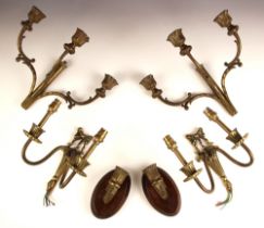 A pair of three branch patinated brass candle sconces, 20th century, the central column supporting