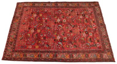 A hand knotted Persian Lilihan wool rug, in red, blue and brown colourways, the central red field p