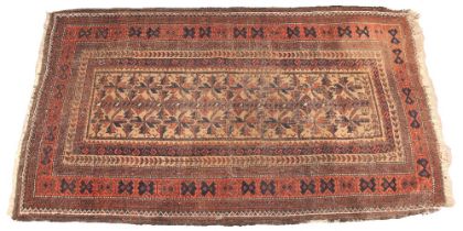 A Caucasian wool rug, in red, blue and brown colourways, the central field with rows of stylised