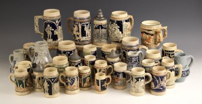 A collection of German stoneware beer steins, 19th century and later, each with relief moulded