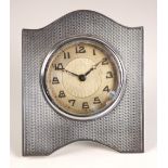 A George V silver bedside timepiece, possibly James Geraghty, Birmingham 1930, the engine turned