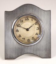 A George V silver bedside timepiece, possibly James Geraghty, Birmingham 1930, the engine turned