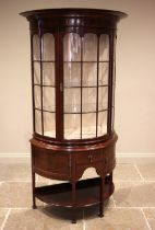An Edwardian mahogany bow front display cabinet, in the manner of Edwards and Roberts, with an