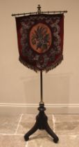 A Victorian Aesthetic Movement pole screen, the beadwork shield shaped banner, upon a brass pole