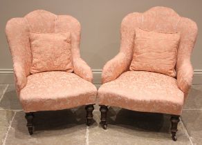 A near pair of Edwardian upholstered salon chairs, re-upholstered in pink damask foliate fabric,