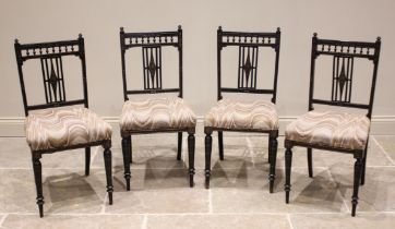 A set of four Victorian Aesthetic Movement chairs, each with a spindled gallery over an open work