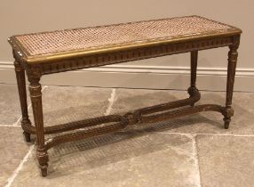 A Louis XVI style giltwood and cane work window seat or stool, late 19th/early 20th century, the