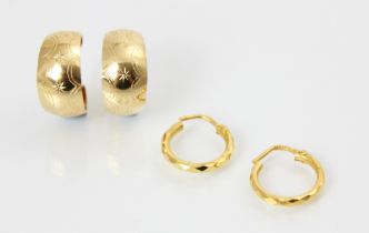 A pair of yellow metal hoop earrings, the faceted hoops with post fittings, stamped ‘916’ with a