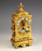 A French gilt metal baroque boudoir timepiece, late 19th century, the case cast with side scroll