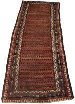 A hand knotted Persian wool runner, in red, blue, green and ivory colourways, the central red