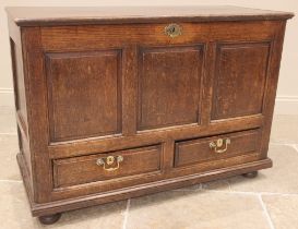 An 18th century oak mule chest, the hinged cover over three front panels and a pair of drawers