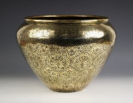 A Persian brass jardiniere, 19th century, the ovoid form planter externally decorated with Eastern