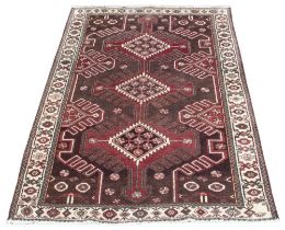 A Persian pattern hand knotted wool carpet, in autumnal colourways, the three central serrated