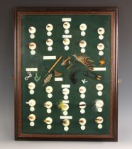 ANGLING INTEREST: A glazed display case, 20th century, containing a selection of mounted fishing